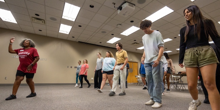 Students dancing in a line.